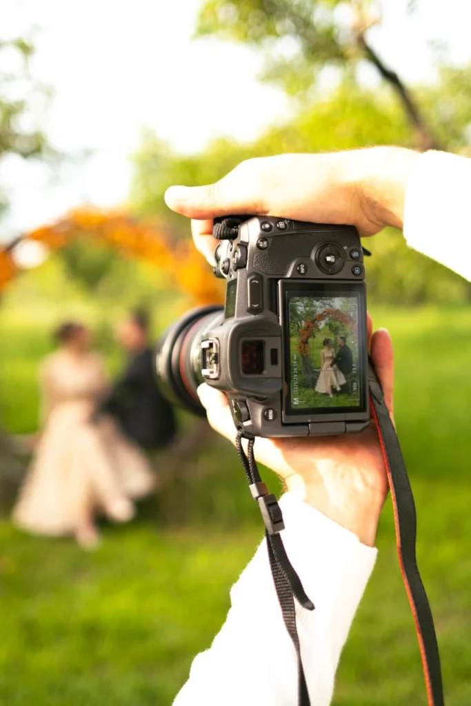 Camera capturing a wedding couple outdoors